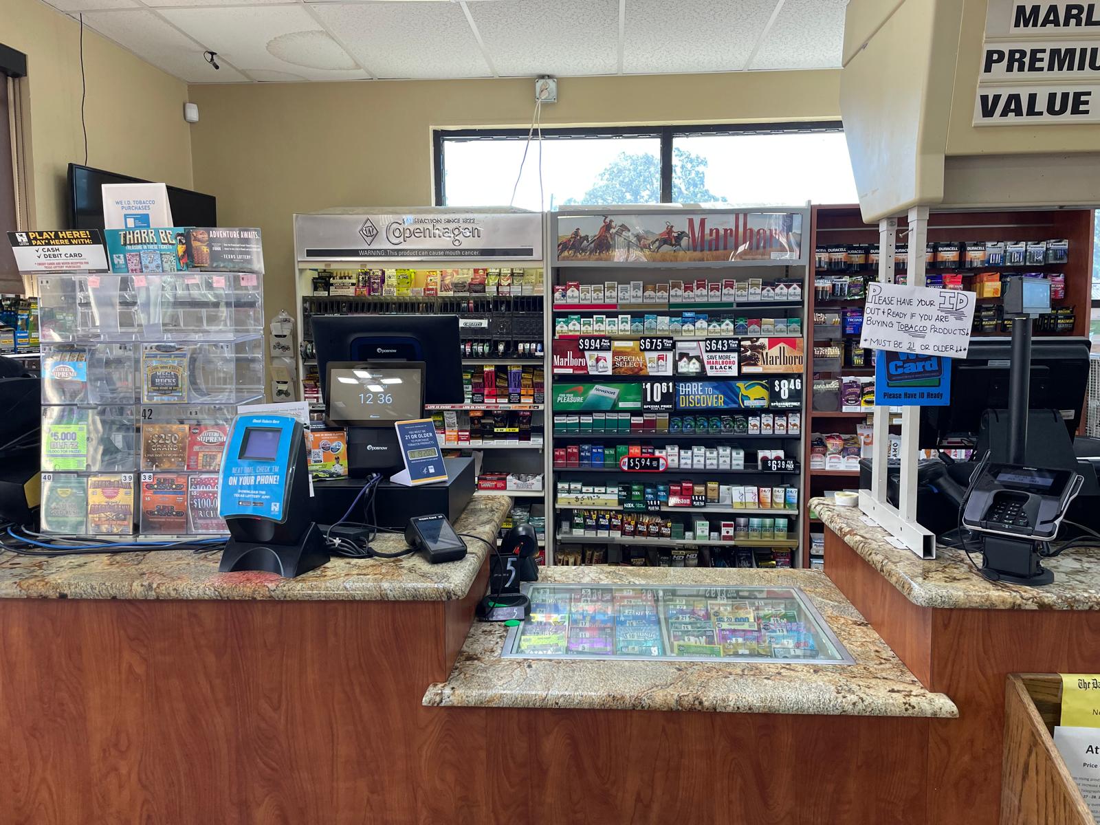 ZSM Express cashier counter with Texas lottery tickets, cigarettes, and professional POS system